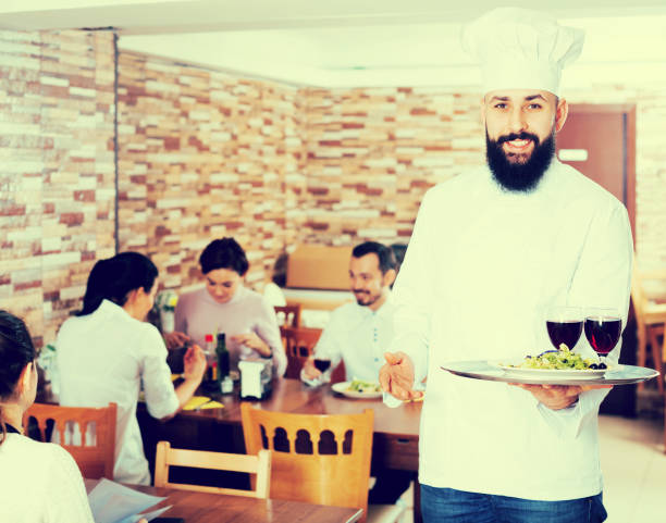 istock Chef taking care of adults at cafe table 849354636