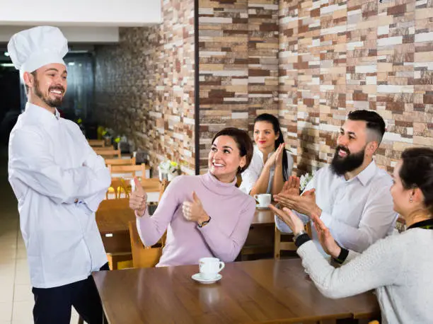 Photo of Happy chef listens to praise of the food