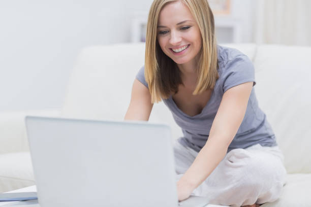 istock Casual happy woman using laptop at home 849356960