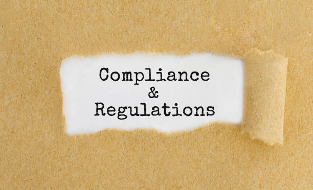 istock Text Compliance and Regulations appearing behind ripped brown paper 849357388