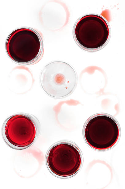 istock Wine glasses with red wine on the stained white table 849371880