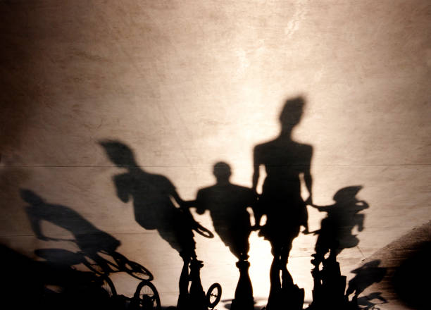 istock Blurry shadows of people walking on summer promenade 849379706