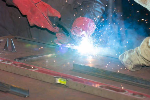 istock Metalworking shop workers work behind machines 849380278