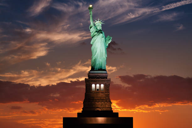 статуя свободы на закате с голубым и красным небом, нью-йорк. - statue of liberty usa new freedom стоковые фото и изображения