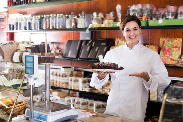 istock Glad seller offering festive chocolate cake 849384608