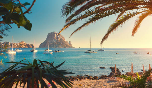 Cala d'Hort beach Cala d'Hort beach. Cala d'Hort in summer is extremely popular, beach have a fantastic view of the mysterious island of Es Vedra. Ibiza Island, Balearic Islands. Spain moored photos stock pictures, royalty-free photos & images