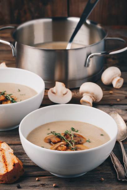 istock Cream soup puree with mushroom on wooden background 849394314