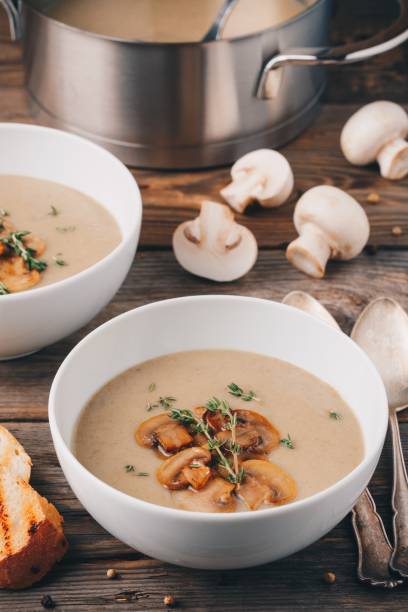 istock Cream soup puree with mushroom on wooden background 849394442