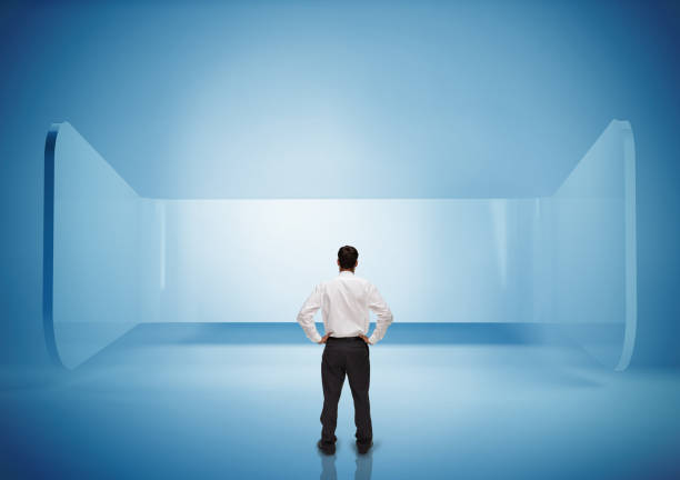 istock Rear view of businessman standing in blue light 849403000