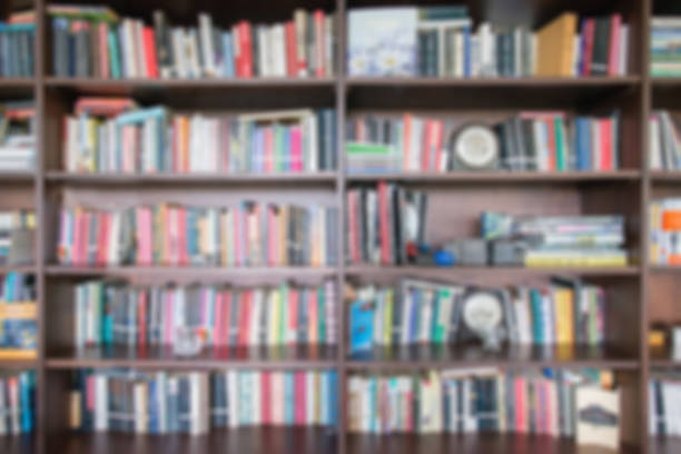 istock Abstract blur and defocused bookshelf in library interior for background.vintage bookshelf with many books for education in library 849403206