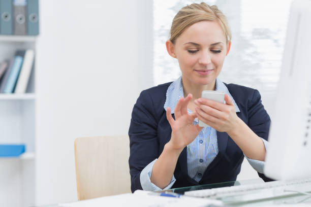 istock Business woman text messaging at office desk 849403518