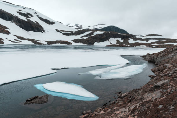 istock Typical norwegian landscape with snowy mountains 849410386