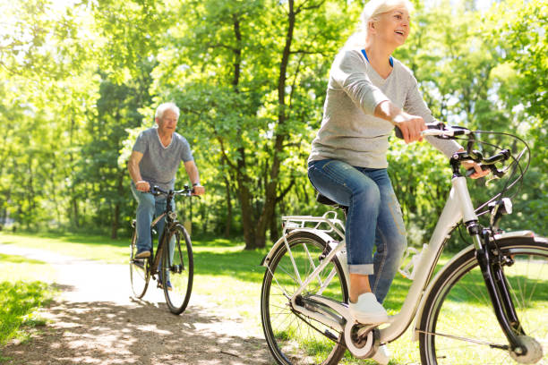 istock Senior Couple Riding Bikes In Park 849410632