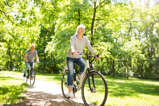 istock Senior Couple Riding Bikes In Park 849411544