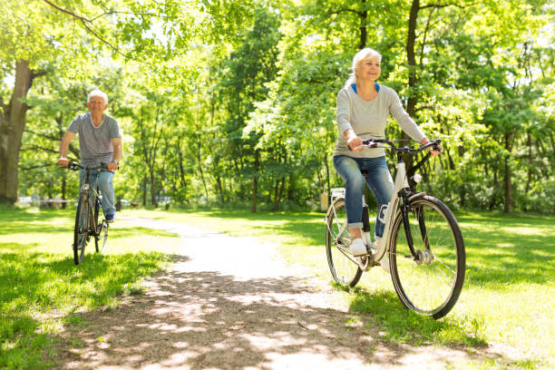istock Senior Couple Riding Bikes In Park 849411904
