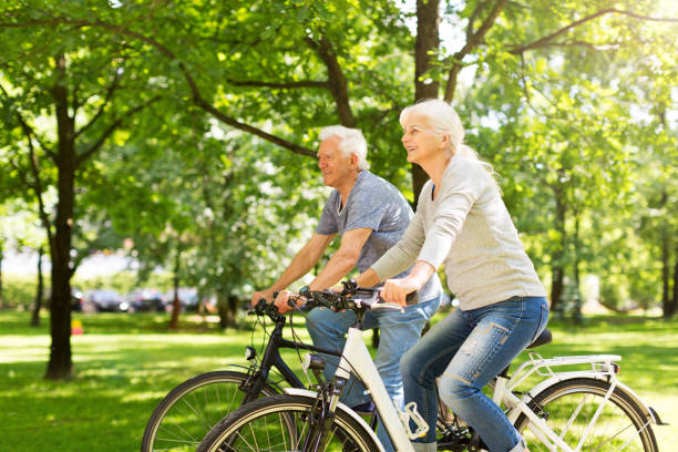 istock Senior Couple Riding Bikes In Park 849413084