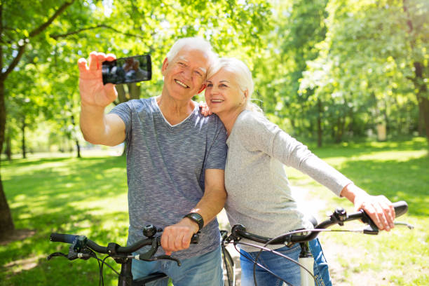 istock Senior couple with bicycles taking selfie 849413252