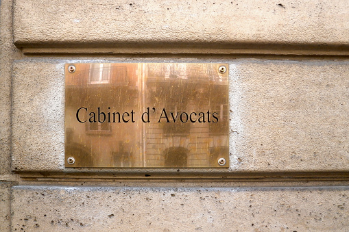 Nameplate at the entrance of a building with written in French \