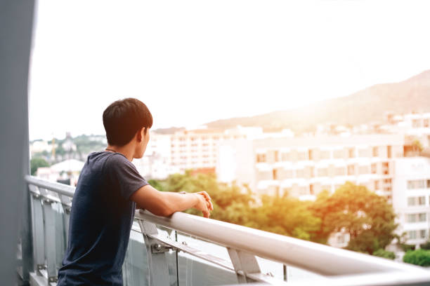 istock Lonely men are looking city view and sunset 849427856