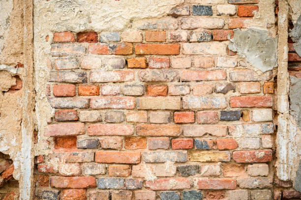 istock Orange brick cracked concrete vintage brick wall background 849436134