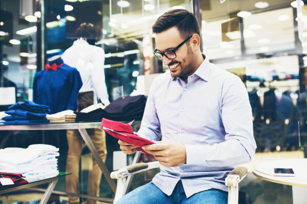 istock Handsome young man buying clothes in the store 849446854