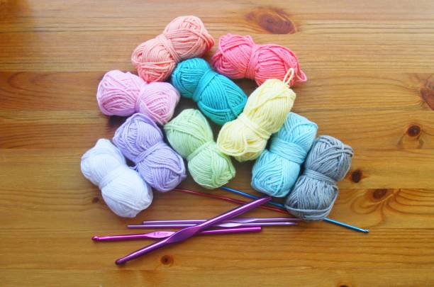 istock Crochet hooks and colourful threads on wooden background 849450640