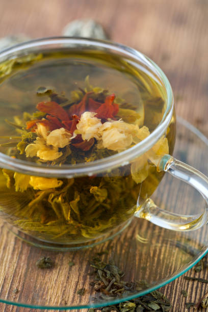 istock exotic green tea with flowers in glass cup 849455268