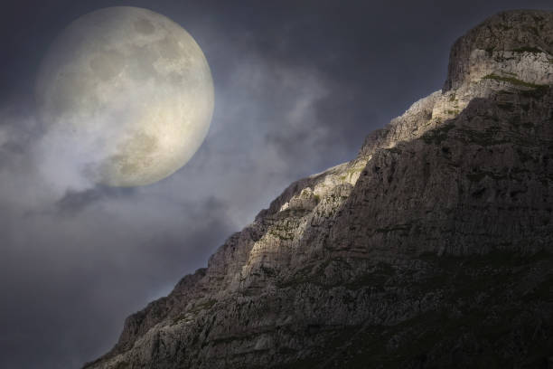 istock Full Moon rises over the rocky summit 849466412