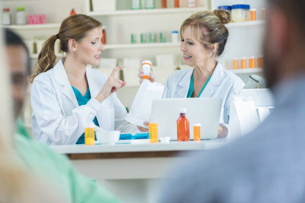 istock Confident female pharmacist gestures while talking with a colleague 849466698