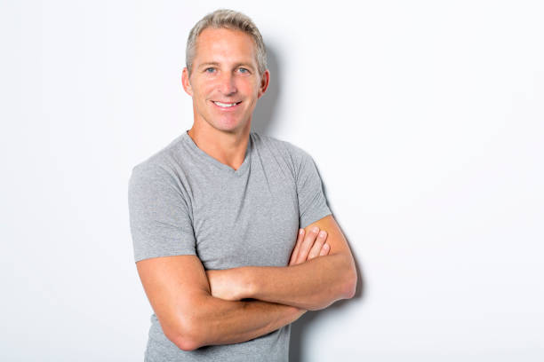 istock Portrait of confident mature man standing on white background 849479738