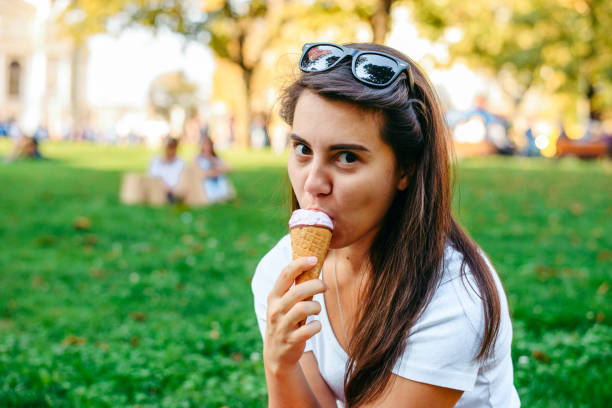 istock young pretty woman take a rest in shadow with ice cream 849480002