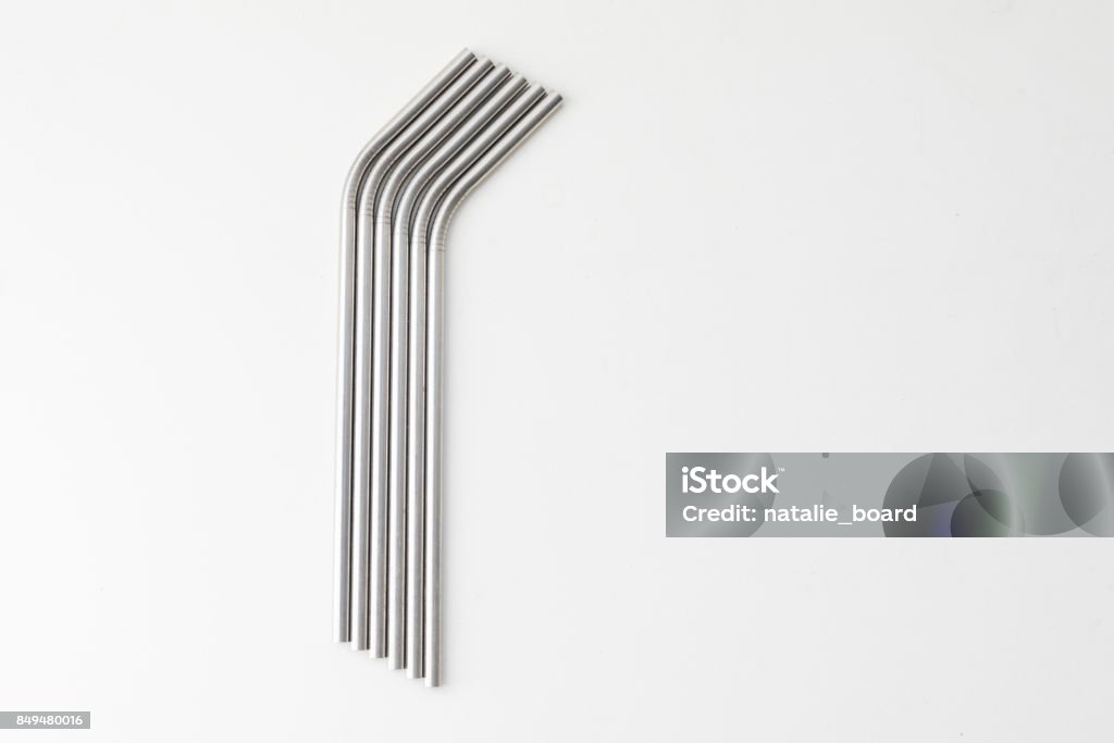 Metal straws from above High angle view of six metal drinking straws arranged on white background Drinking Straw Stock Photo