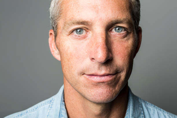 istock Closeup portrait of a man over a dark grey background 849482502