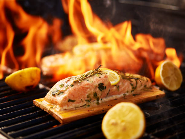 istock cedar plank salmon with lemon and rosemary on grill 849482696