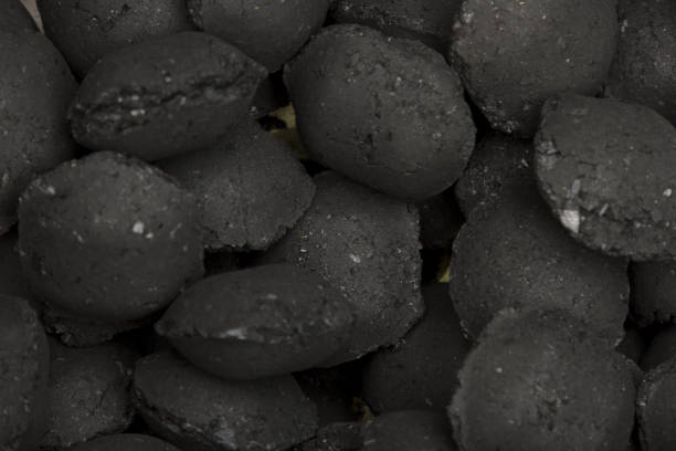istock Charcoal Briquettes For BBQ Grill Background Texture Close-up Overhead View 849482982