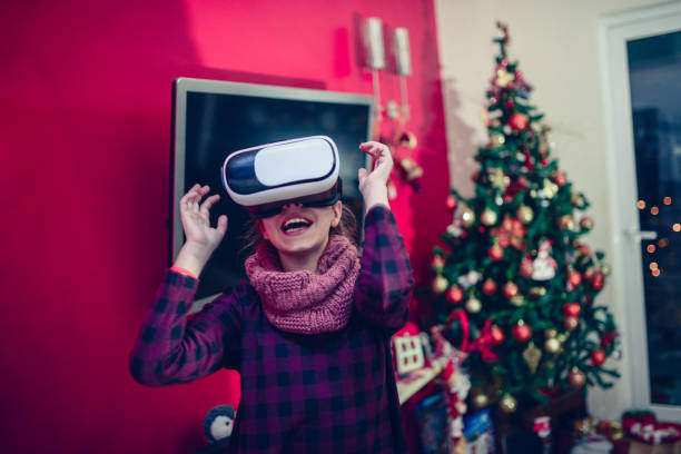 istock Little Girl Having Fun with Virtual Reality Simulator at Christmas Night 849486646