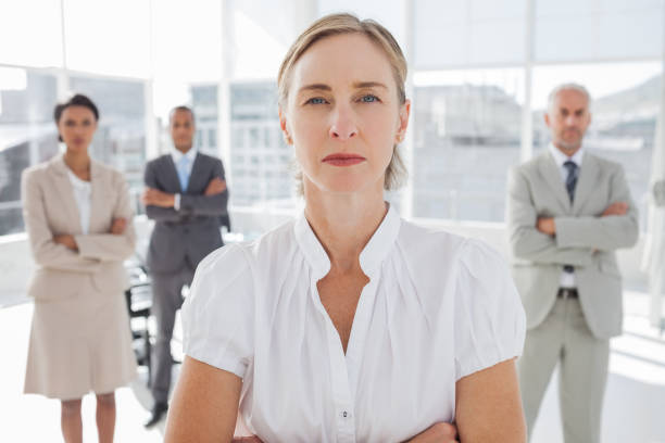 istock Serious businesswoman standing with arms folded 849494096
