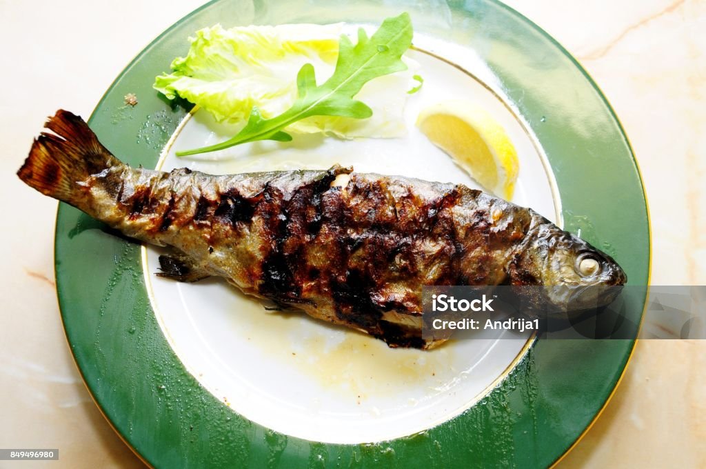 Barbacue grilled trout fish served on dish Barbacue grilled trout fish Balsamic Vinegar Stock Photo