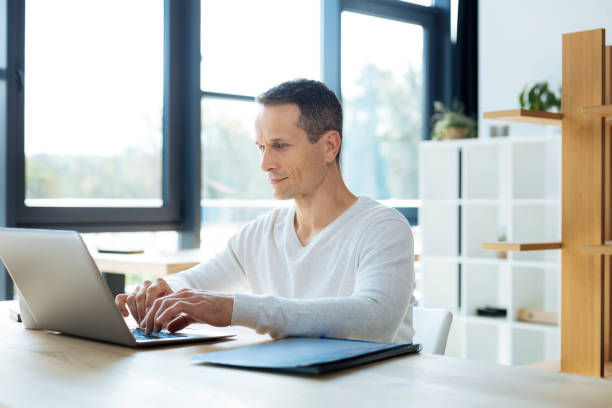 istock Handsome cheerful businessman typing on the keyboard 849497396