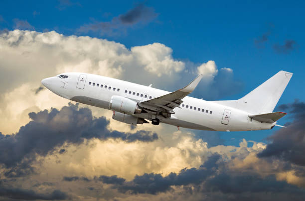 istock Passenger airplane flies in the sky gaining height above the clouds 849500212