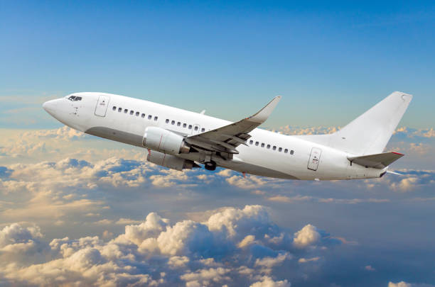 istock Passenger airplane flies in the sky gaining height above the clouds 849500214