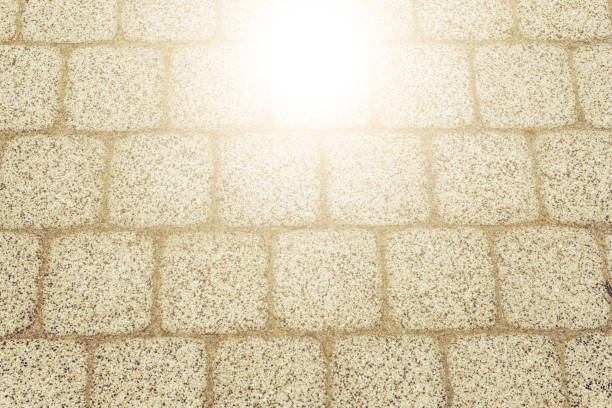 Abstract background of old cobblestone pavement texture with natural patterns view from above. Vintage tone