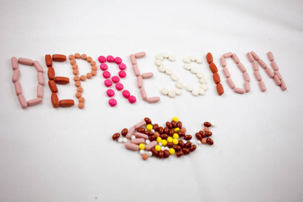 istock A depression word, writing on the white background on pills with copy space. 849507074