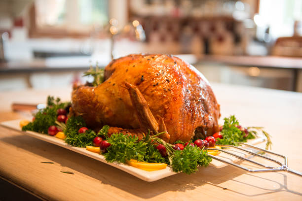 istock Thanksgiving Roast Turkey garnish and platter on rustic wooden table 849513562