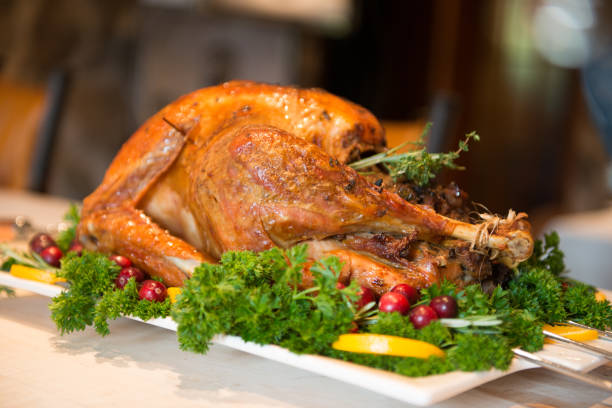 istock Thanksgiving Roast Turkey garnish and platter on rustic wooden table 849513930