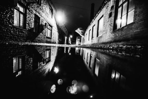 istock Dark backstreet reflected in puddle - Tallinn, Estonia 849517474