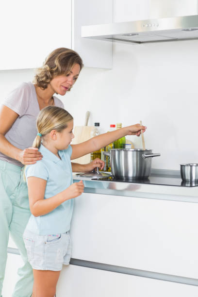 istock Mother teaching daughter how to cook 849520448