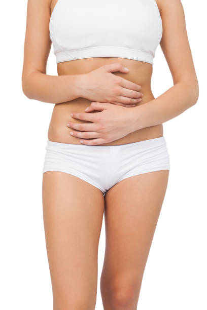 istock Slim woman touching her belly with her hands 849521328