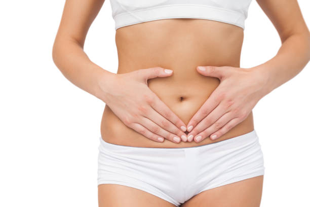 istock Mid section of slim woman touching her belly with her hands 849521384