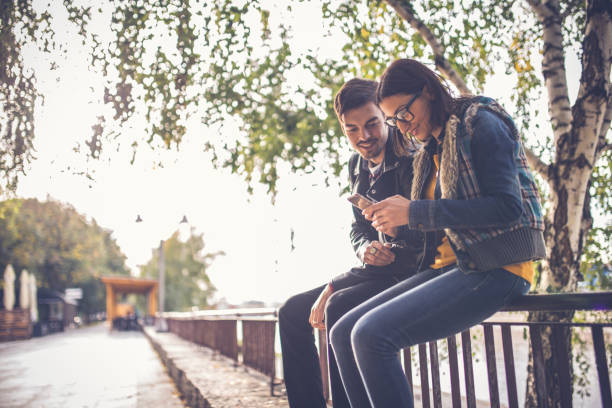 istock Young couple sitting in public park 849525196